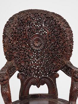 A pair of carved 'blackwood' armchairs, Bombay presidency, British Raj, circa 1880.