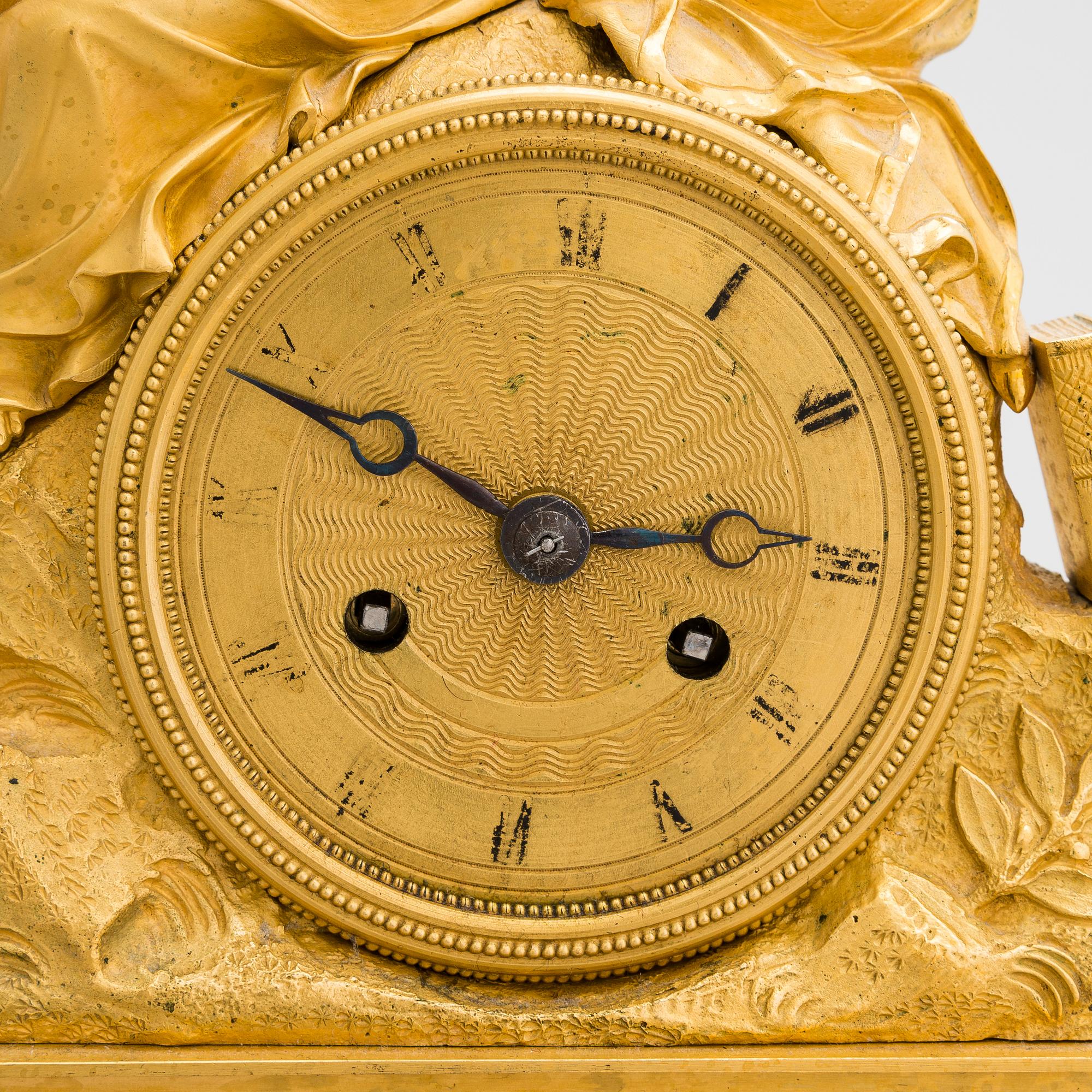 A French Empire mantel clock from 1820s-30s.