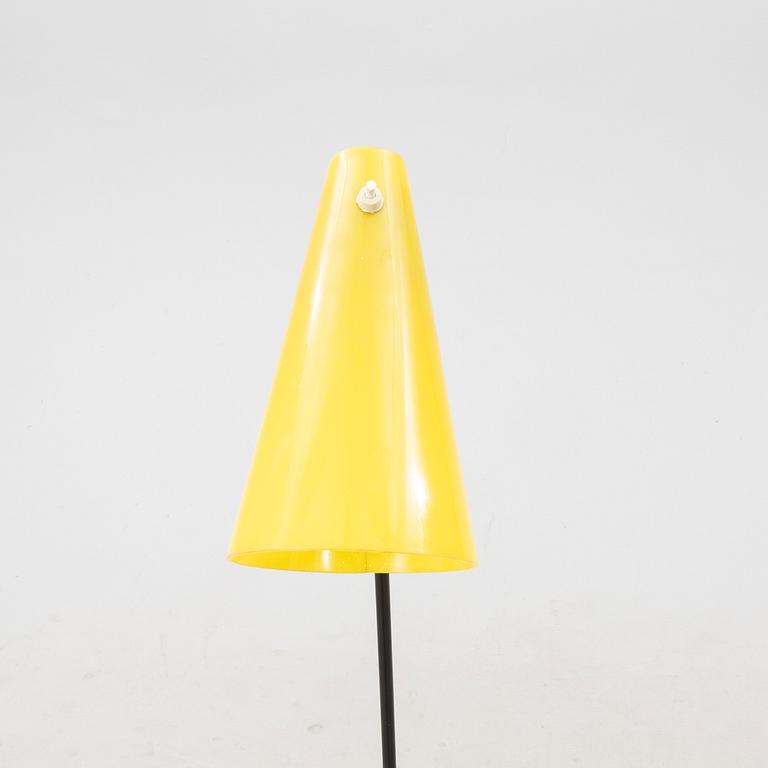 A 1050s metal and plastic floor lamp.