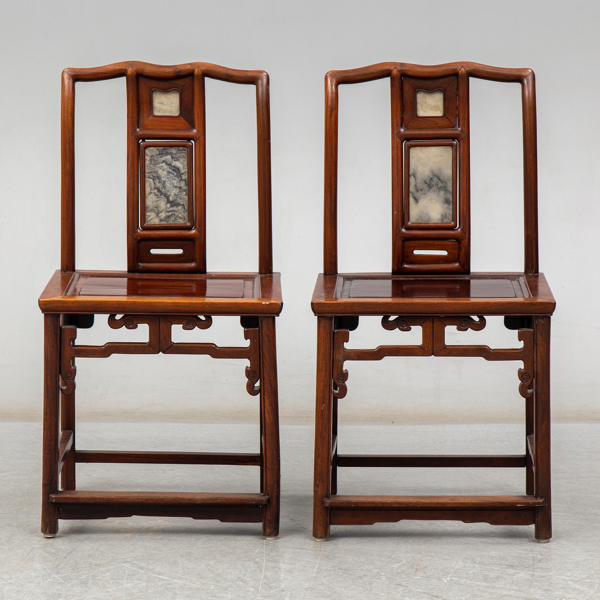 A pair of Chinese hardwood armchairs, early 20th century.