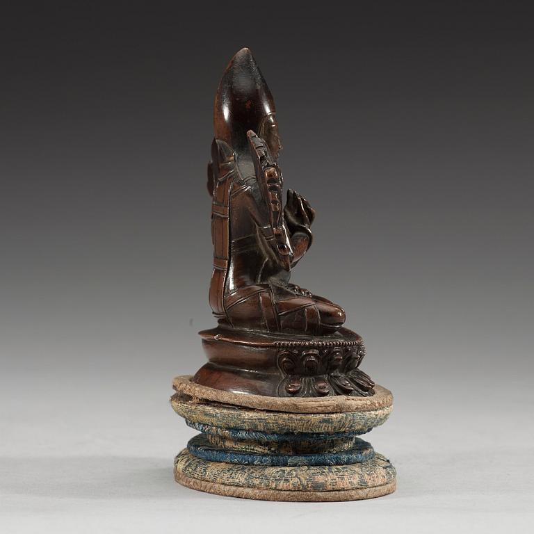 A copper alloy seated figure of a Tsong Khapa, presumably Nepal, 19th Century or older.