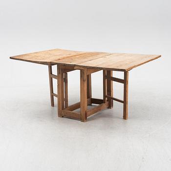 A pine gateleg table, 19th Century.