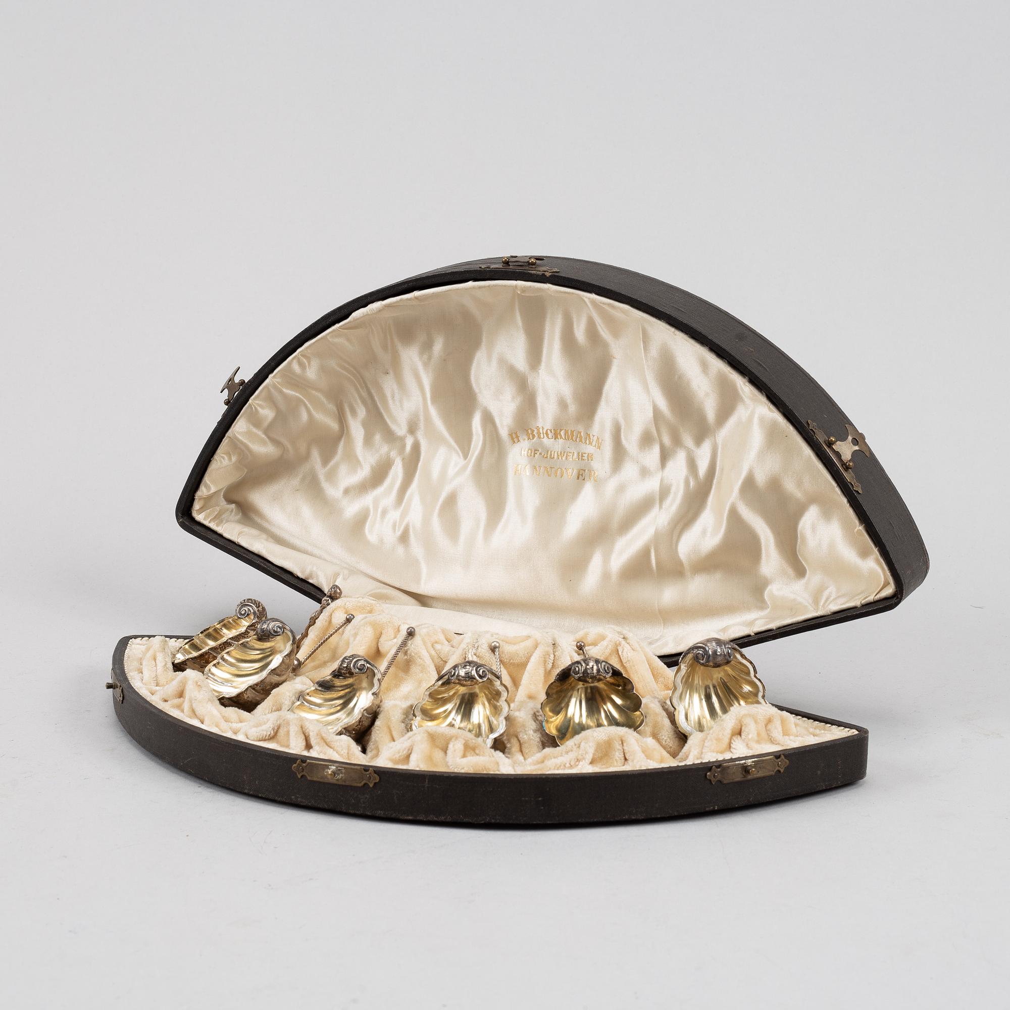 A set of six German parcel-gilt silver 800 salt cellars in fitted case.