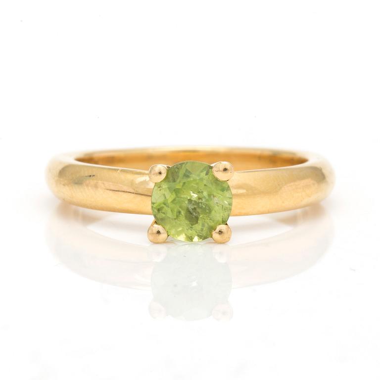 A ring with round, mixed-cut peridot.