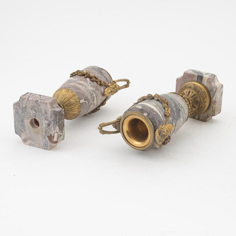 A pair of Louis XVI style urns with covers.