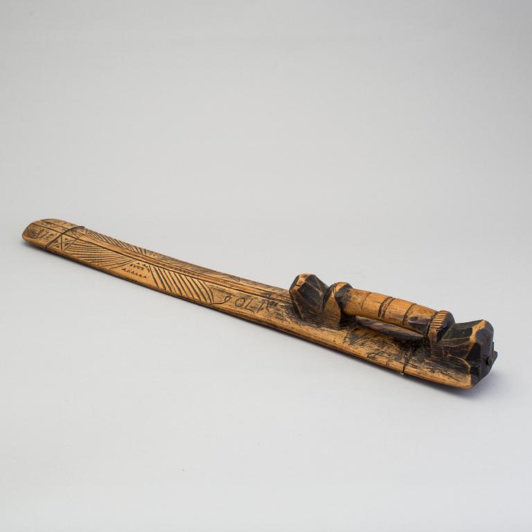 A carved folk art mangle board dated 1706.