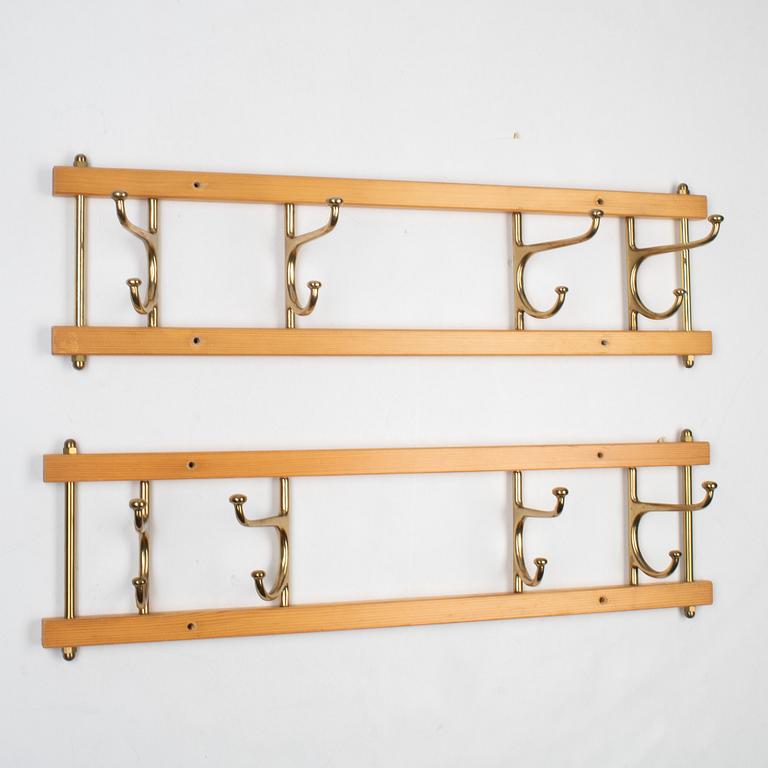 A pair of 'Dekorativ' coat hangers, Skoglunds metallgjuteri, Anderstorp, mid 20th Century.