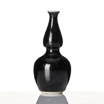 A calebass shaped black glazed vase, Qing dynasty, 19th century.