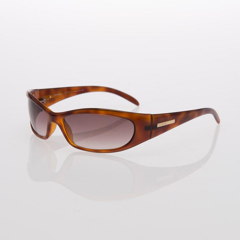 Two Pairs of Sunglasses, Prada and Chanel.