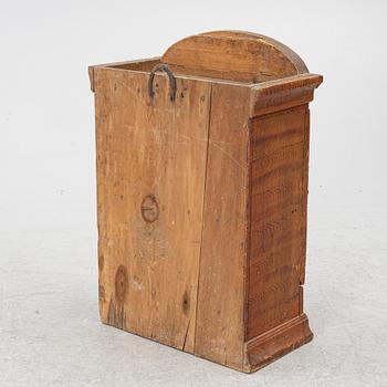 A hanging cabinet, dated 1850.