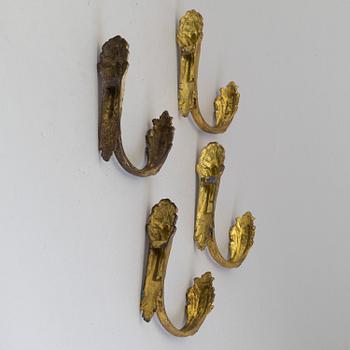 A SET OF FOUR BRONZE CURTAIN TIE-BACKS, 19th century.