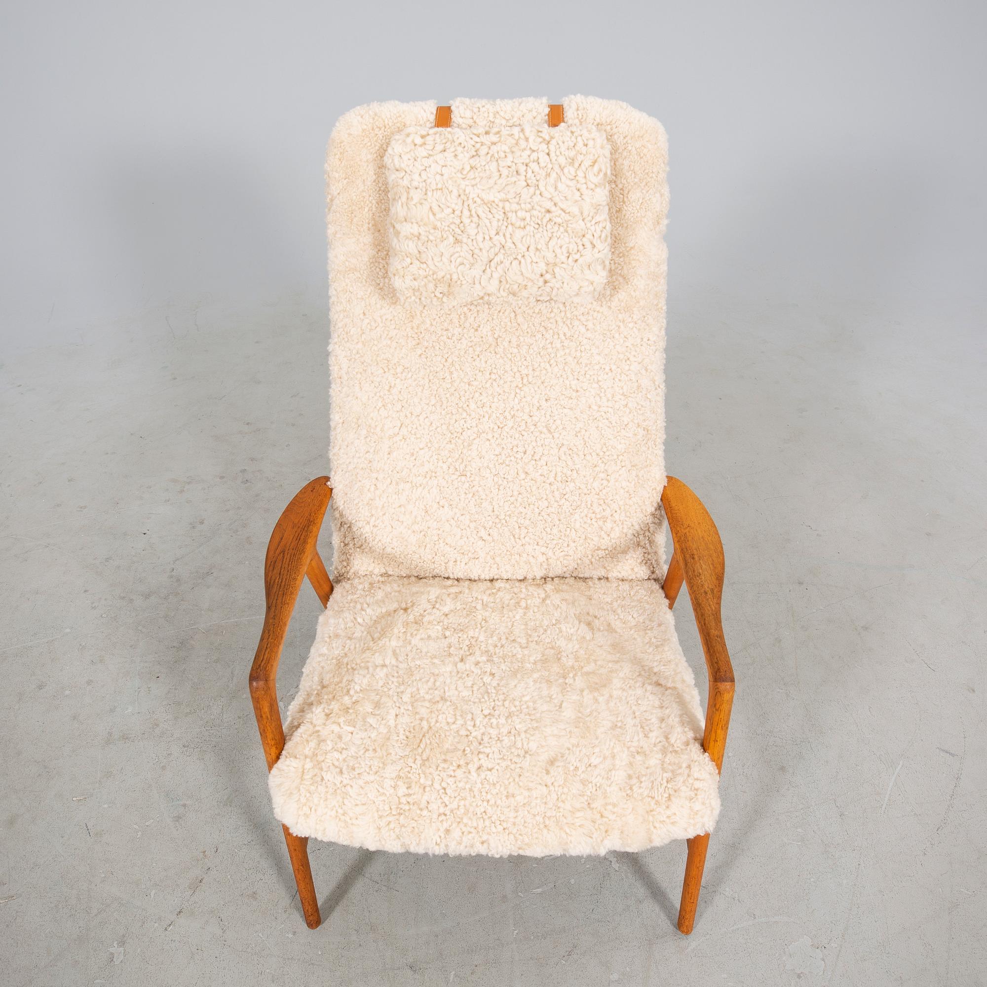 An Alf Svensson Contour-Set 327 sheepskin armchair.