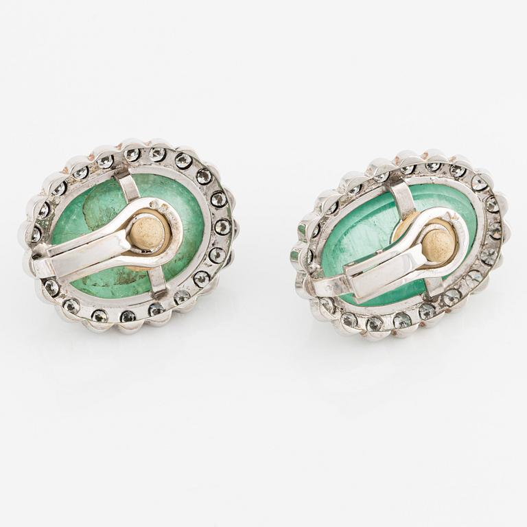 A pair of 18K white gold earrings with cabochon-cut emeralds.