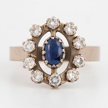 Oval faceted sapphire and brilliant-cut diamond ring.