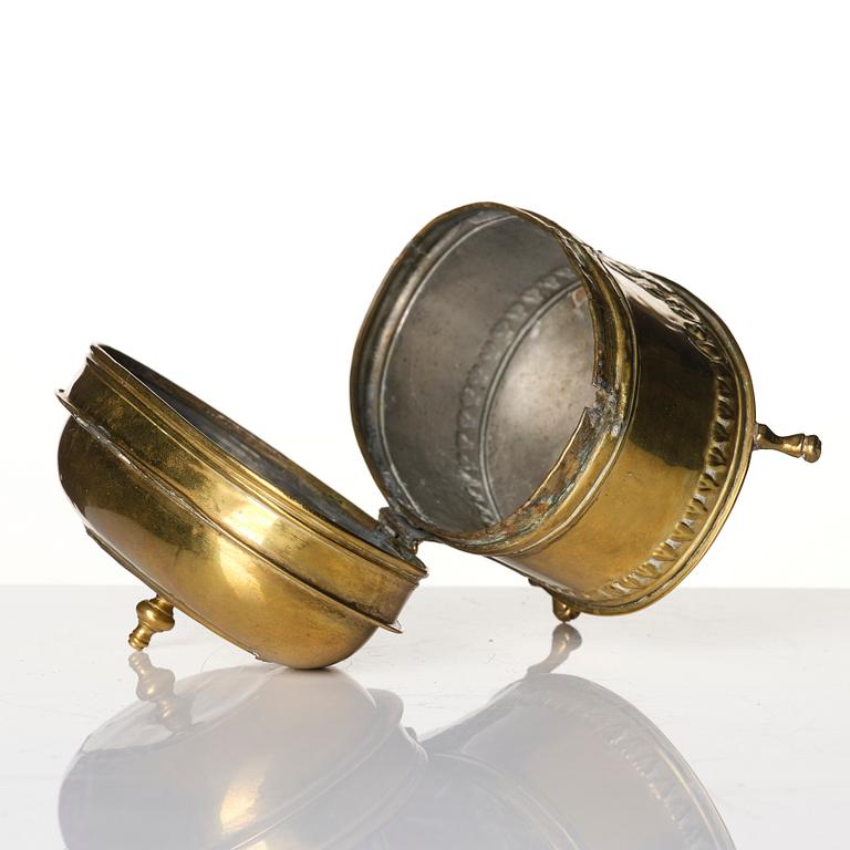 A baroque repousse brass pyxis, 18th century.