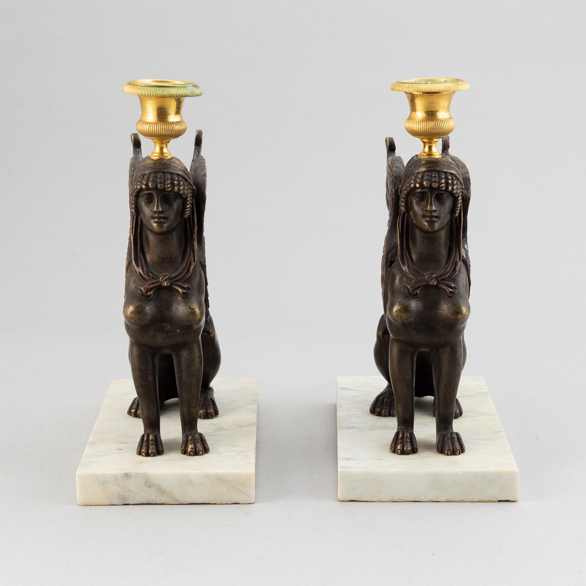 A pair of bronze and marble Empire style candlesticks, first part of the 20th Century.