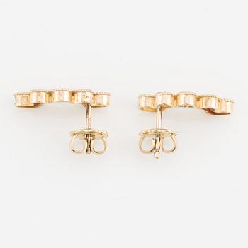 A pair of 14K gold earrings with multicolored sapphires.