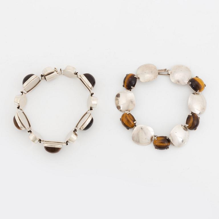 Two silver bracelets set with tiger's eye.