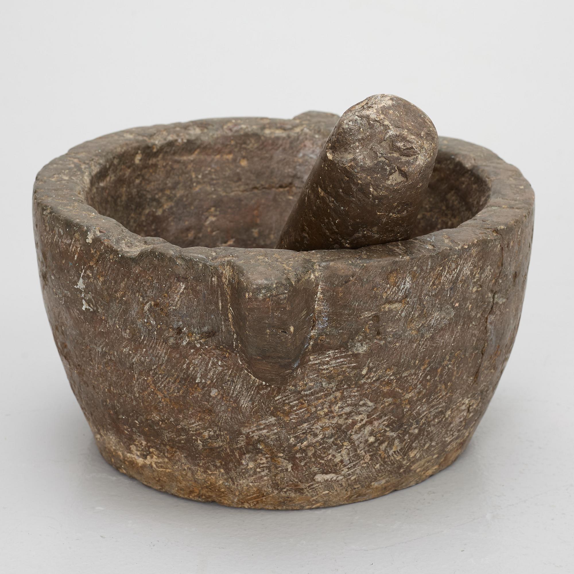 A llimestone mortar and pestle, 18th/19th Century.