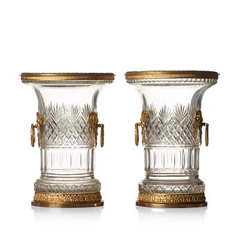 A pair of Empire-style circa 1900 cut glass and gilt-brass urns.