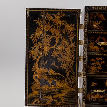 AN early 18TH CENTURY PROBABLY ENGLISH Japanned laquer cabinet on stand.