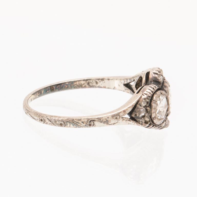 An 18K white gold ring set with rose cut diamonds.