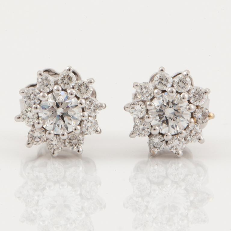 Brilliant-cut diamond floral shaped earrings.