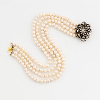Collier/brooch, four-stranded with cultured pearls, clasp with old-cut diamonds.