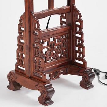 A Chinese wooden floor lamp, later part of the 20th century.