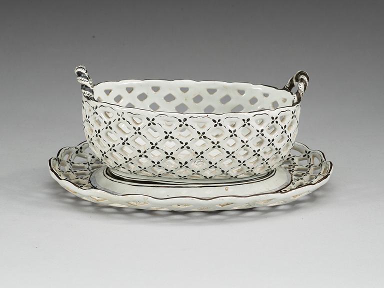 A Swedish Marieberg faience chesnut basket with stand, dated 5/6 and 6/6 (17)71.