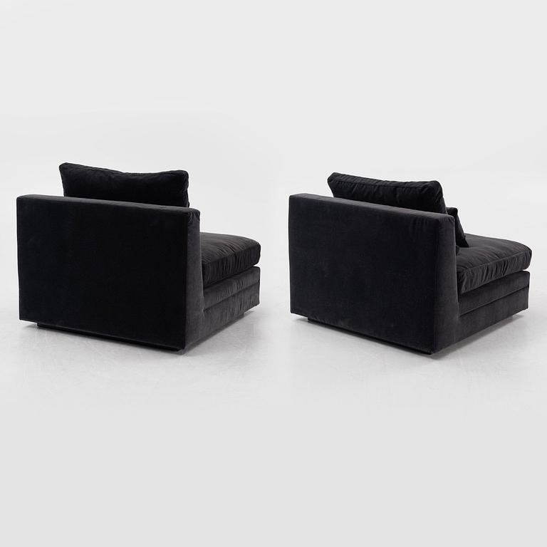 Two 21st century lounge chairs.