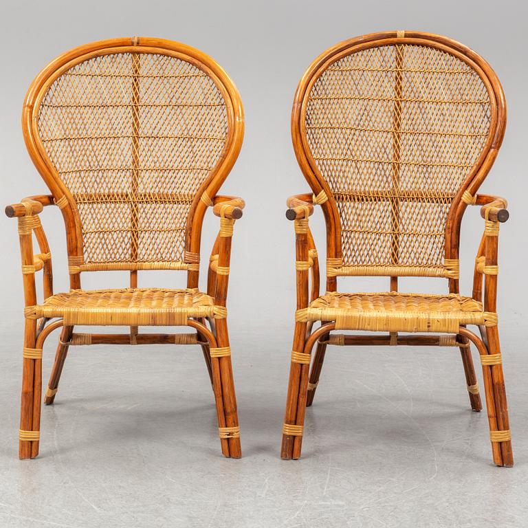 A pair of rattan chairs.