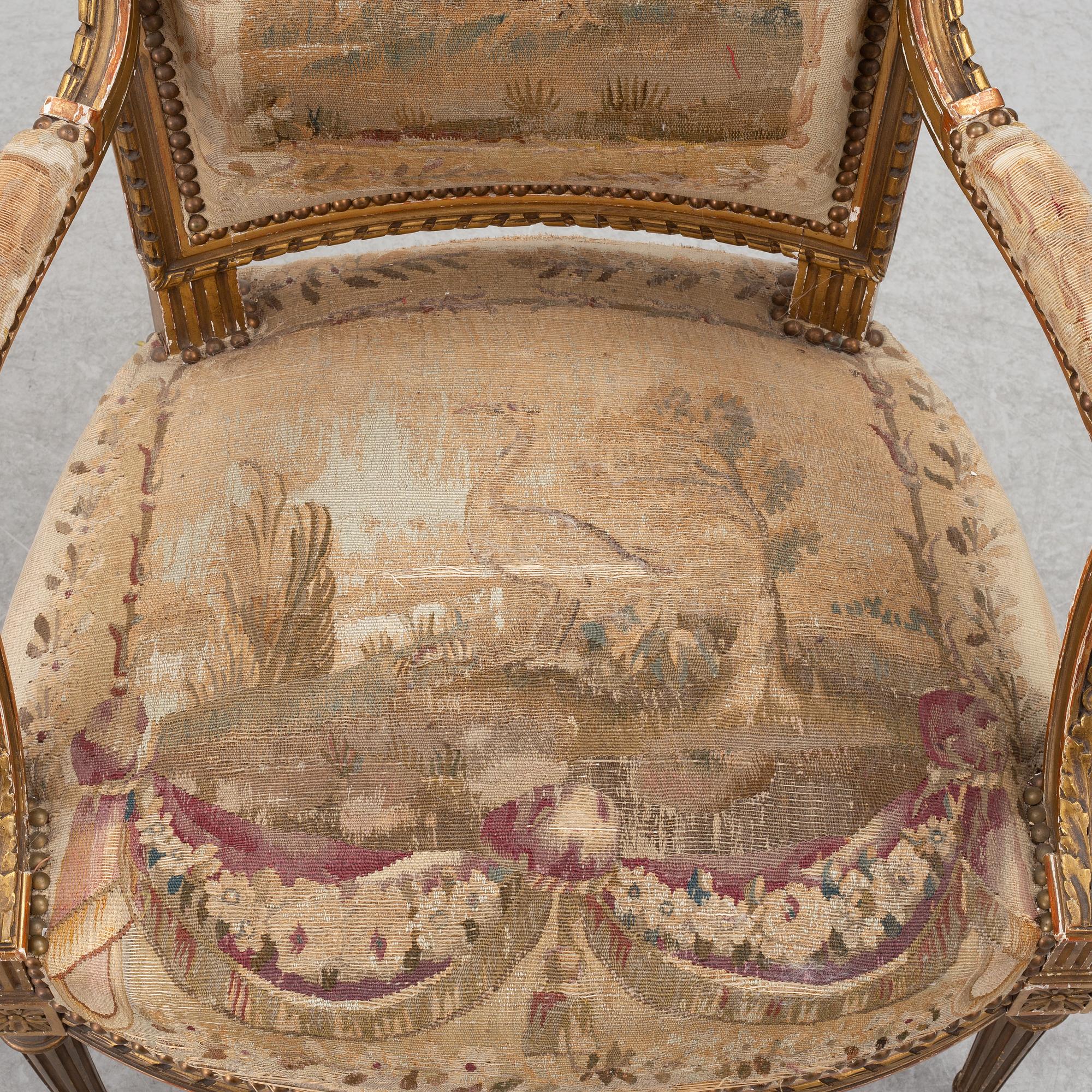 A pair of Louis XVI-style armchairs, late 19th century with 18th century fabric.