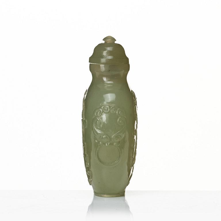 A Chinese carved nephrite snuff bottle with cover.