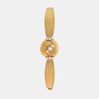 1101. Omega damarmbandsur 18K guld med runda briljantslipade diamanter total vikt ca 0.40 ct.