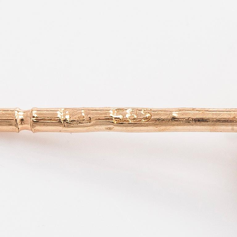 A pair of 14K gold earrings and brilliant cut diamonds.