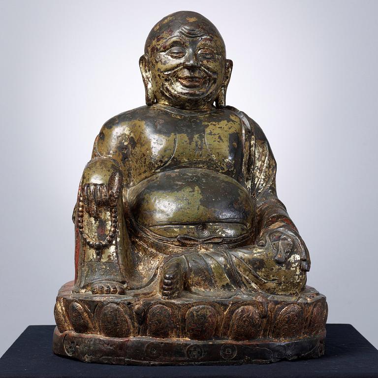 A large seated bronze figure of Budai, Ming Dynasty, dated to the fifth year of Jiajing (1526).
