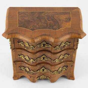 A late Baroque walnut-veneered miniature commode, 20th century.