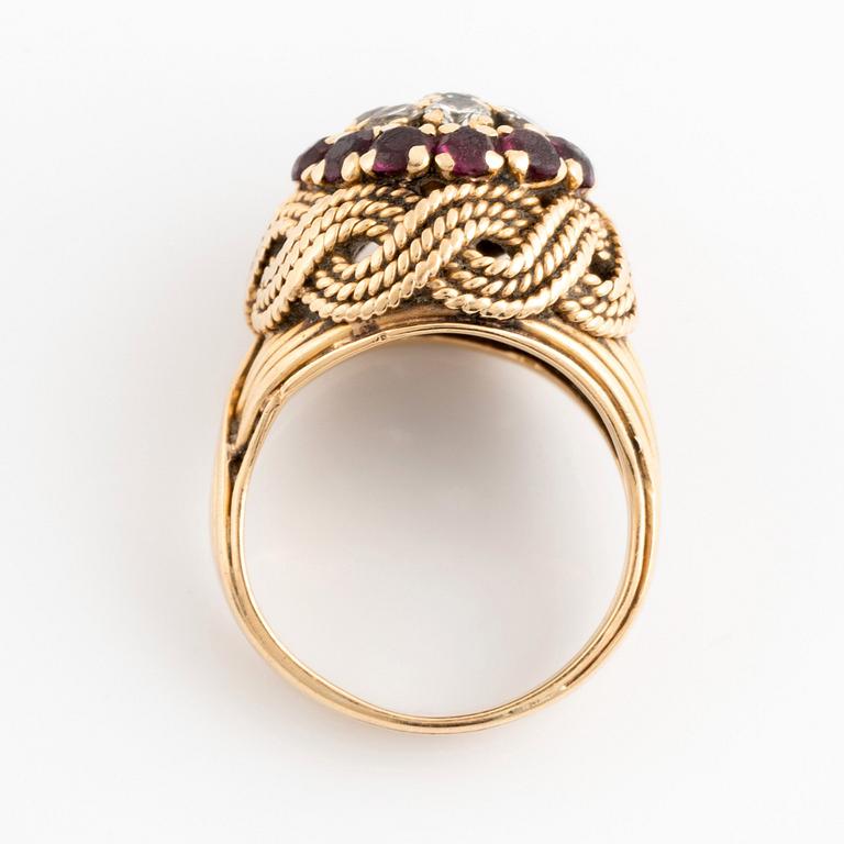 An 18K gold ring set with round brilliant-cut diamonds and rubies.