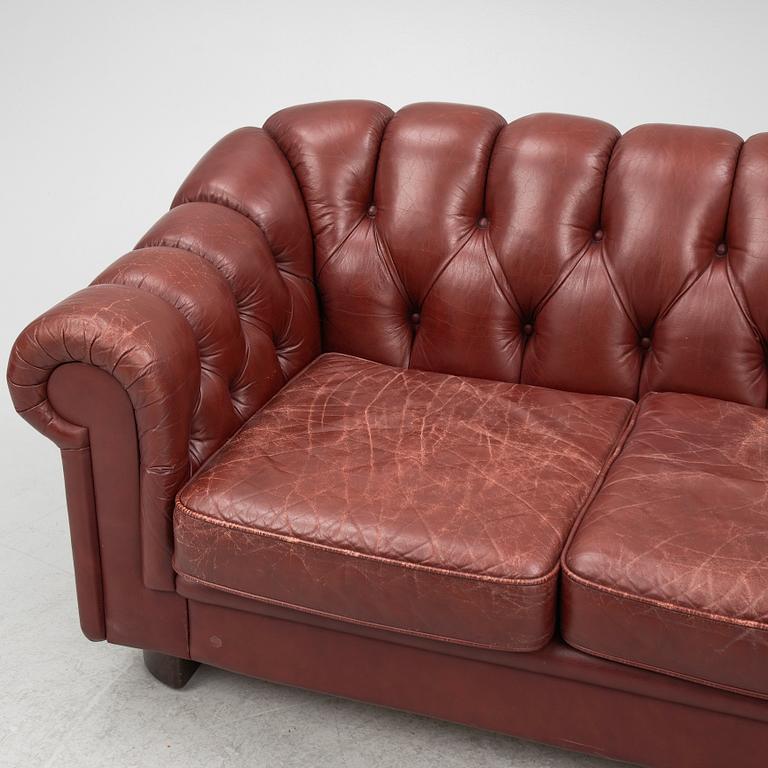 A sofa and a pair of armchairs, 'Chesterfield model', late 20th Century.