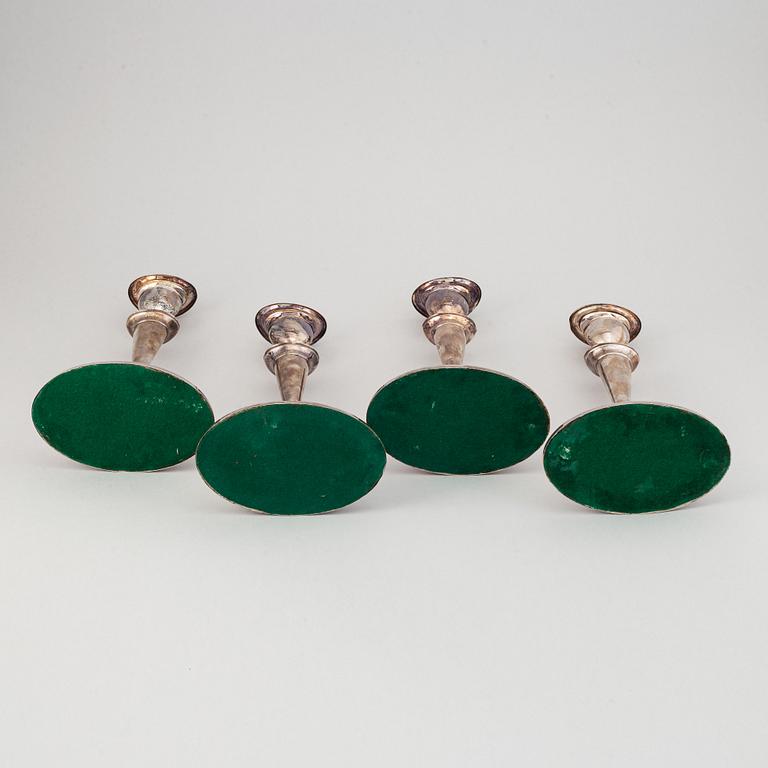 A set of four English 19th century silver-plated candlesticks.