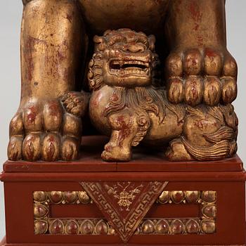 A pair of Chinese massive lacquered Buddhist lions, first half of the 20th Century.