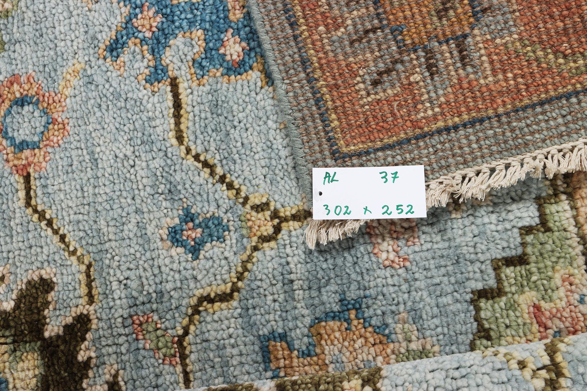 An oriental carpet with Mamluk design, c. 302 x 252 cm.