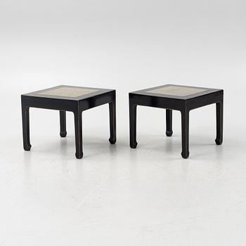 A pair of blac painted side tables with stone tops.