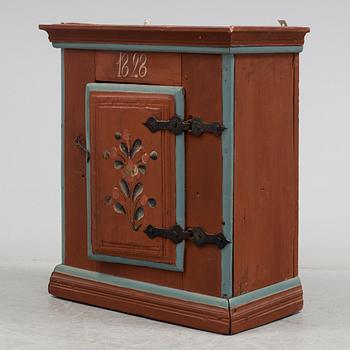 a painted cabinet dated 1828.
