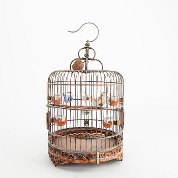 A Chinese bird cage with bird feeders, 20th Century.