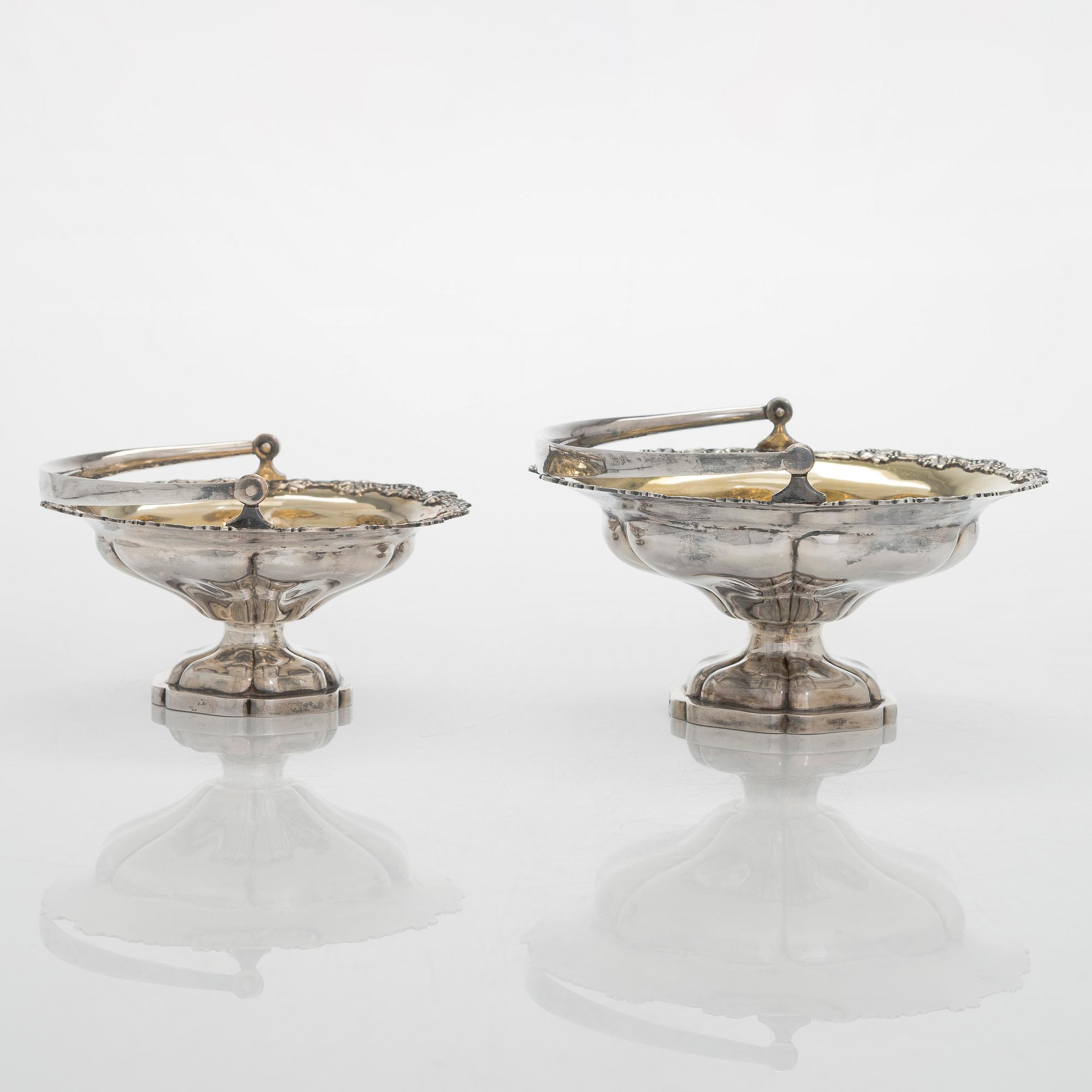 A set of two 1920s-1930s silver sweetmeat basket with sugar tong and jam spoon, Uusi Kultaseppä Oy, Helsinki, Finland.