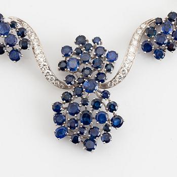 An 18K white gold necklace set with round brilliant-cut diamonds and sapphires.