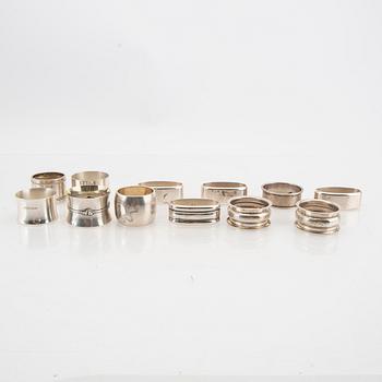 A set of 12 different silver and sterling silver napkinrings total weight 404 grams.