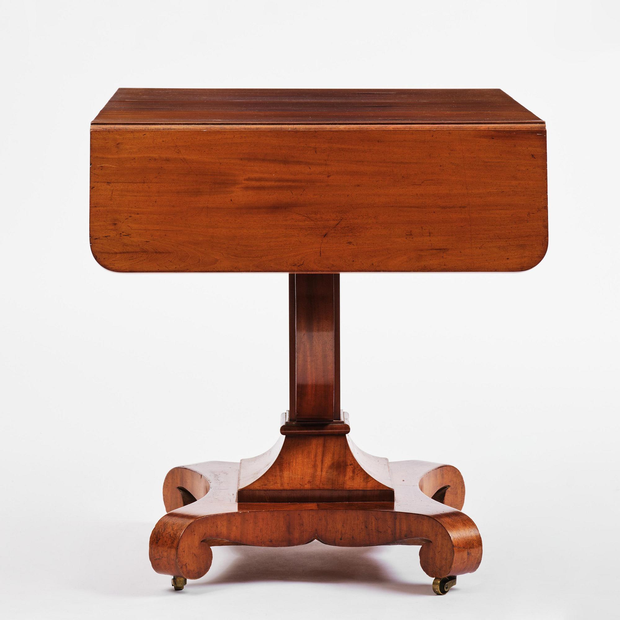 A Swedish Empire mahogany center table.